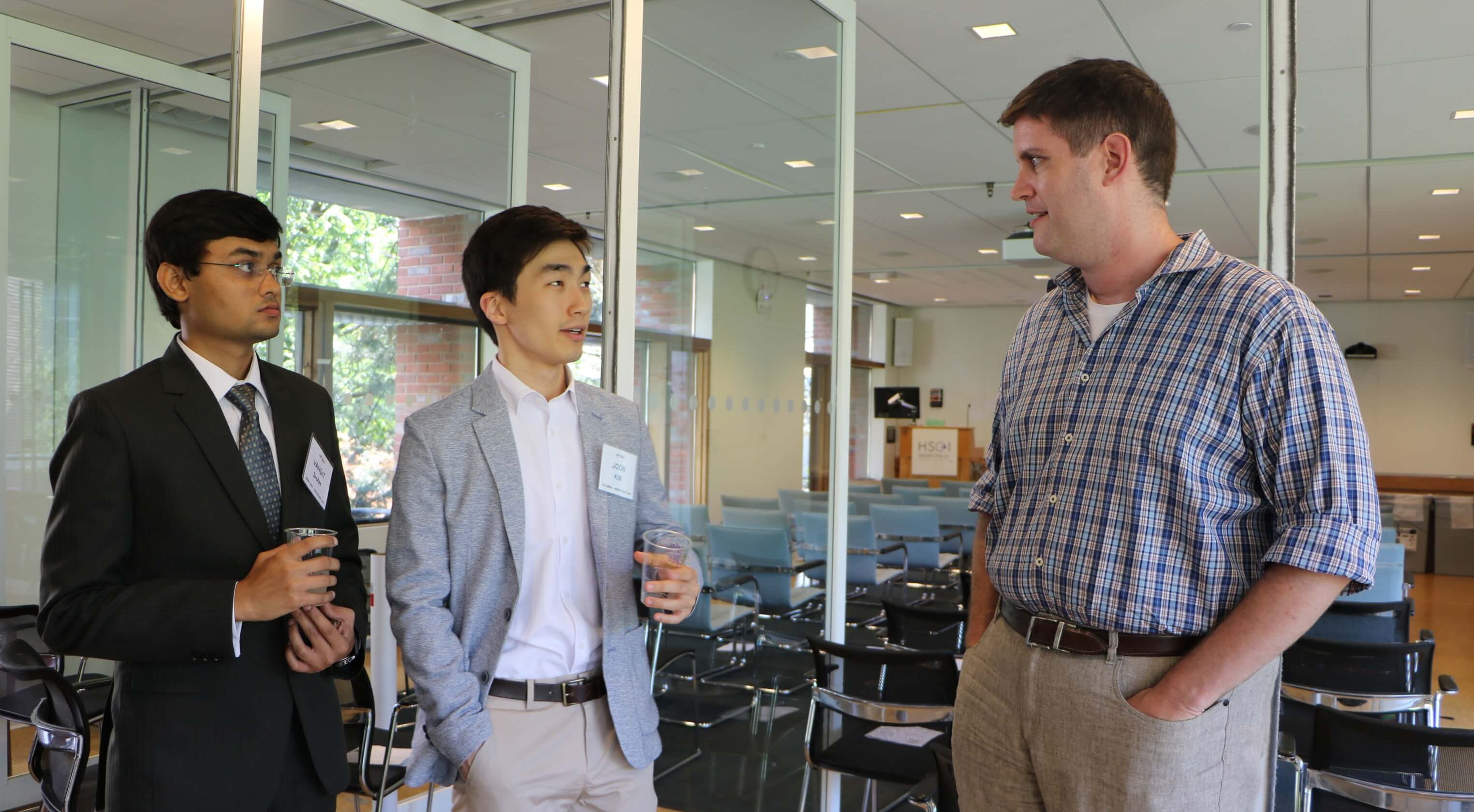 Bill Anderson speaking with two students.