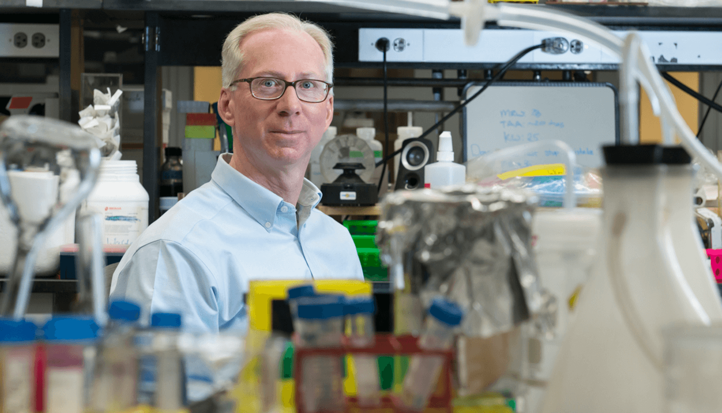 Portrait of Jeff Macklis at a lab bench