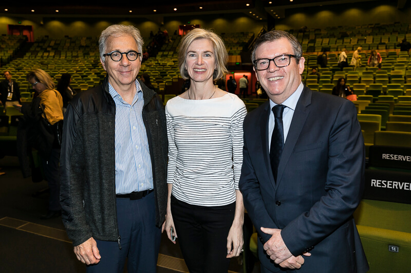 Doug Melton standing with colleagues in an auditorium