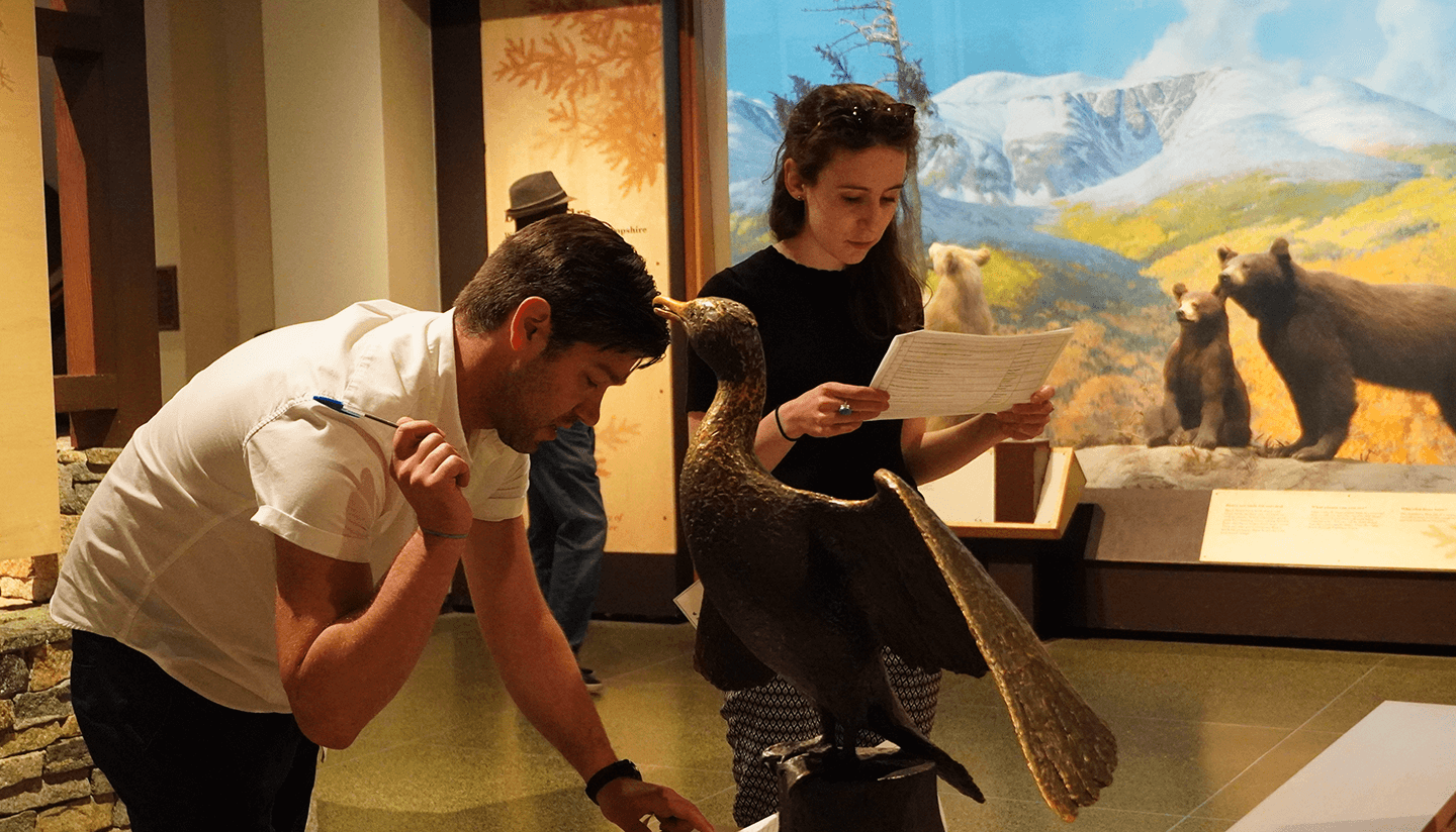 Department members in front of a museum exhibit.