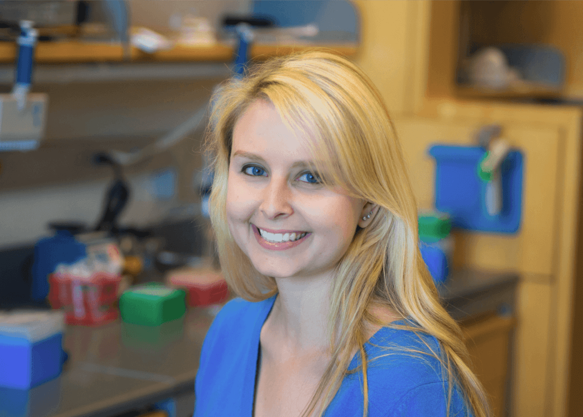 Headshot of a blonde woman wearing a blue shirt