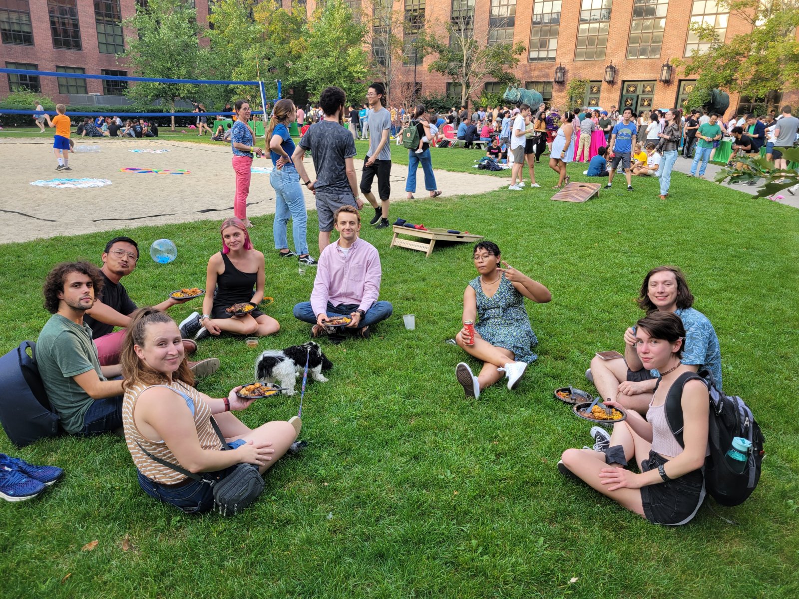 A group of people sitting on the grass