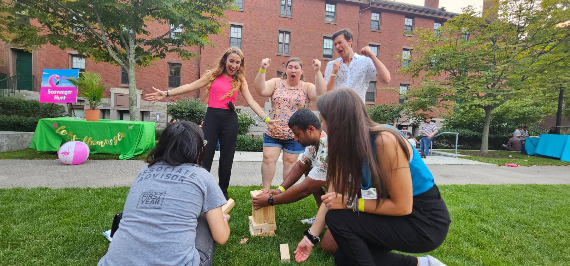 A group of people playing jenga outside
